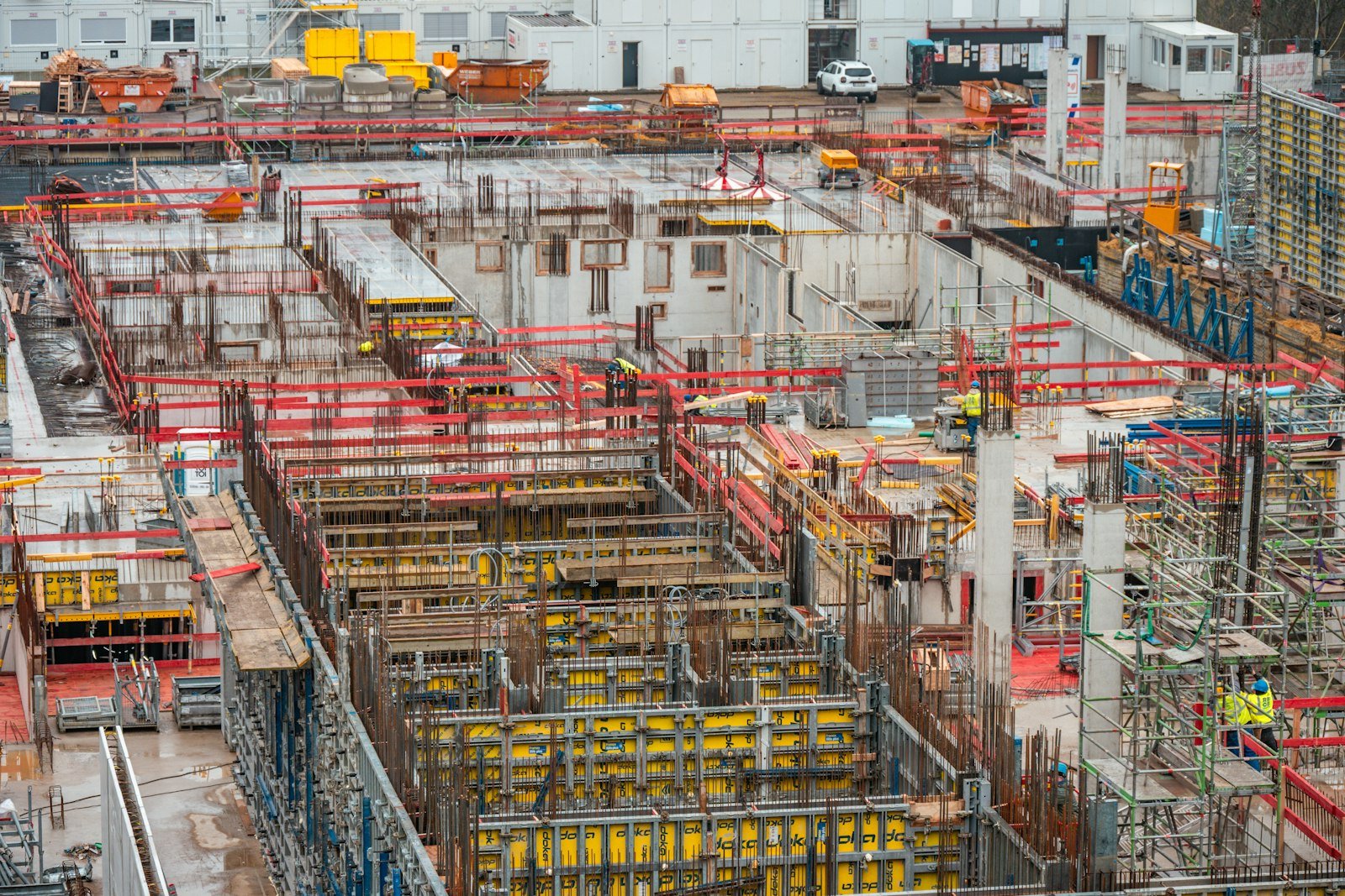 Elevated view of a construction site with formwork, scaffolding and reinforcement in place